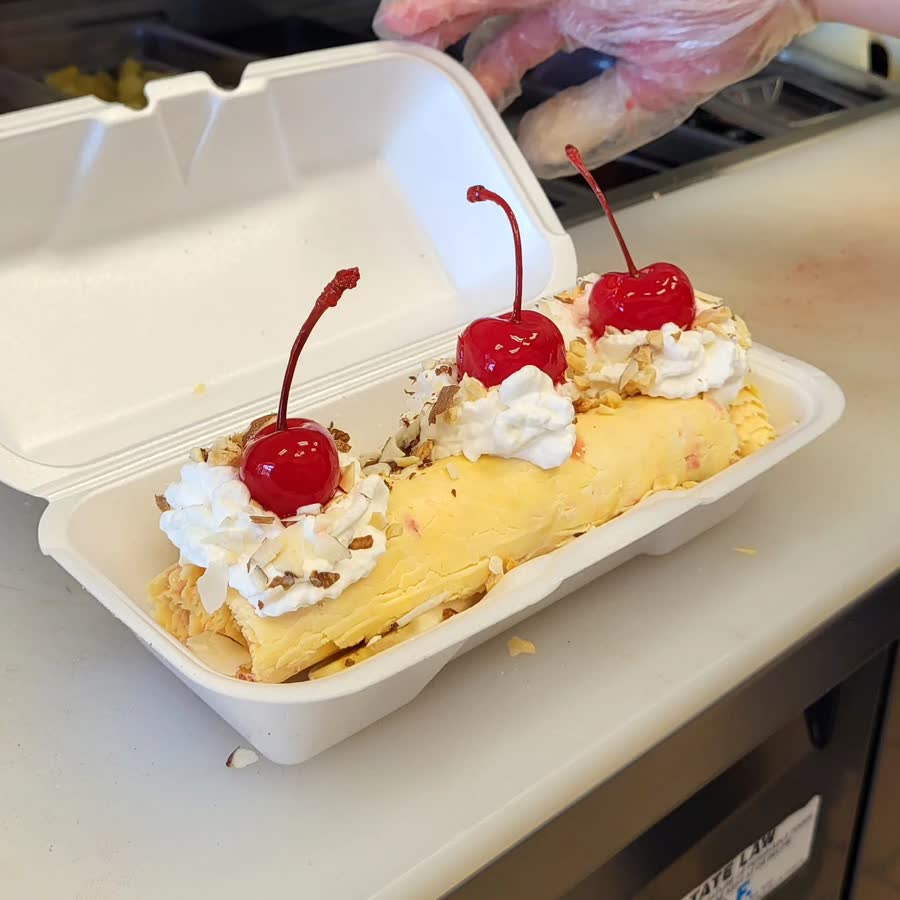 Banana crepe with whipped cream and cherries